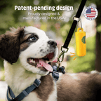 Dog wearing a harness with a yellow device, set against a blurred green outdoor background.